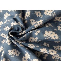 Floral denim with white flower on mid blue denim background. Ideal for dressmaking