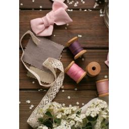 Threads ribbons lace flowers on wooden floorboards. scattered flower petals. wedding