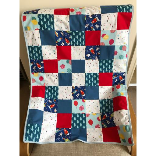 Bold red white and navy blue quilt with balloons and rockets