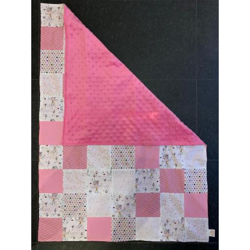 pink and white quilt with pink dimple fleece backing