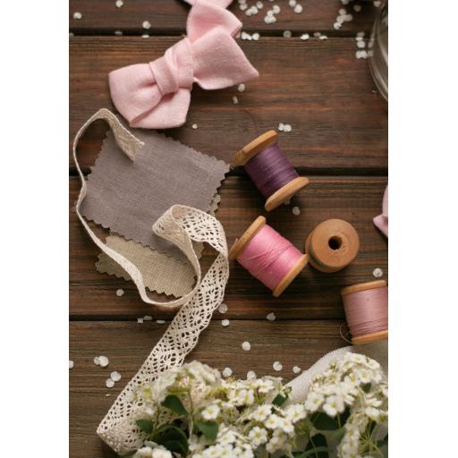 Threads ribbons lace flowers on wooden floorboards. scattered flower petals. wedding